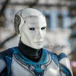 Close-up of a futuristic humanoid robot with metallic armor and blue LED eyes.