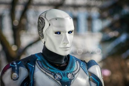 Close-up of a futuristic humanoid robot with metallic armor and blue LED eyes.